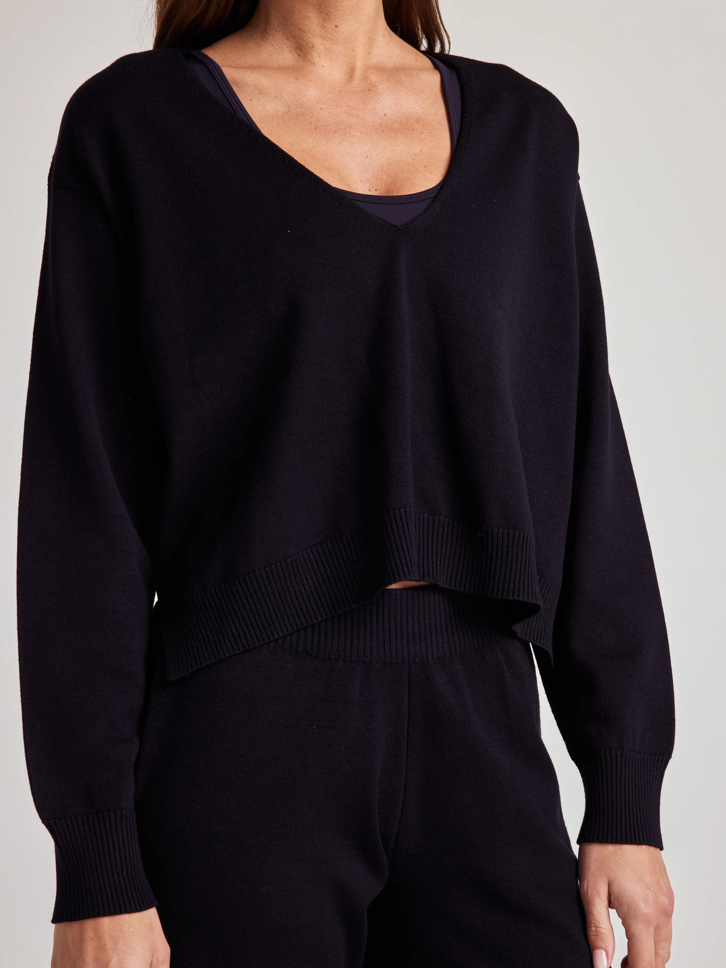 model wears sustainable cozy v neck sweater in black