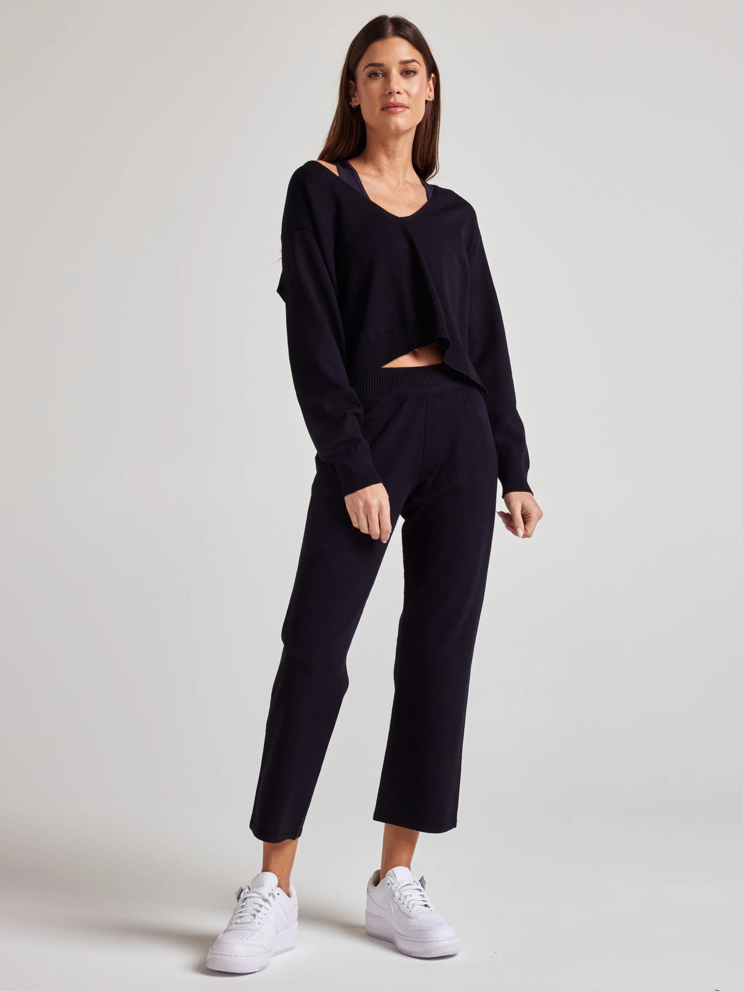model wears sustainable cozy v neck sweater in black