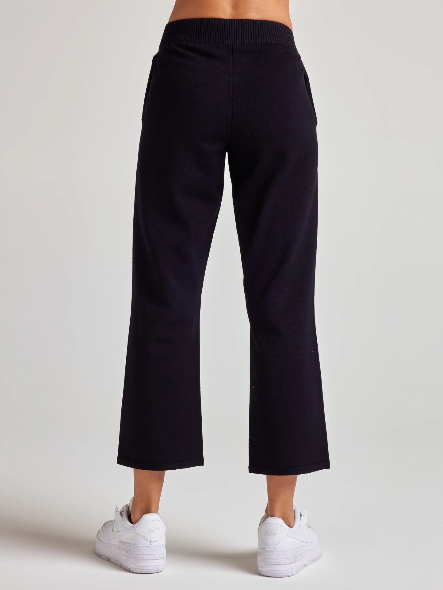 model wears sustainable cropped black knit pants