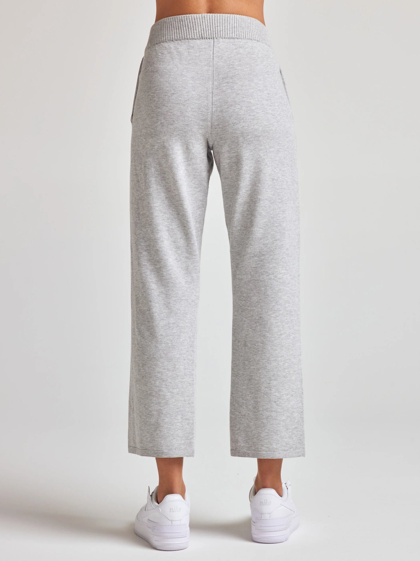 model wears sustainable cropped grey knit pants