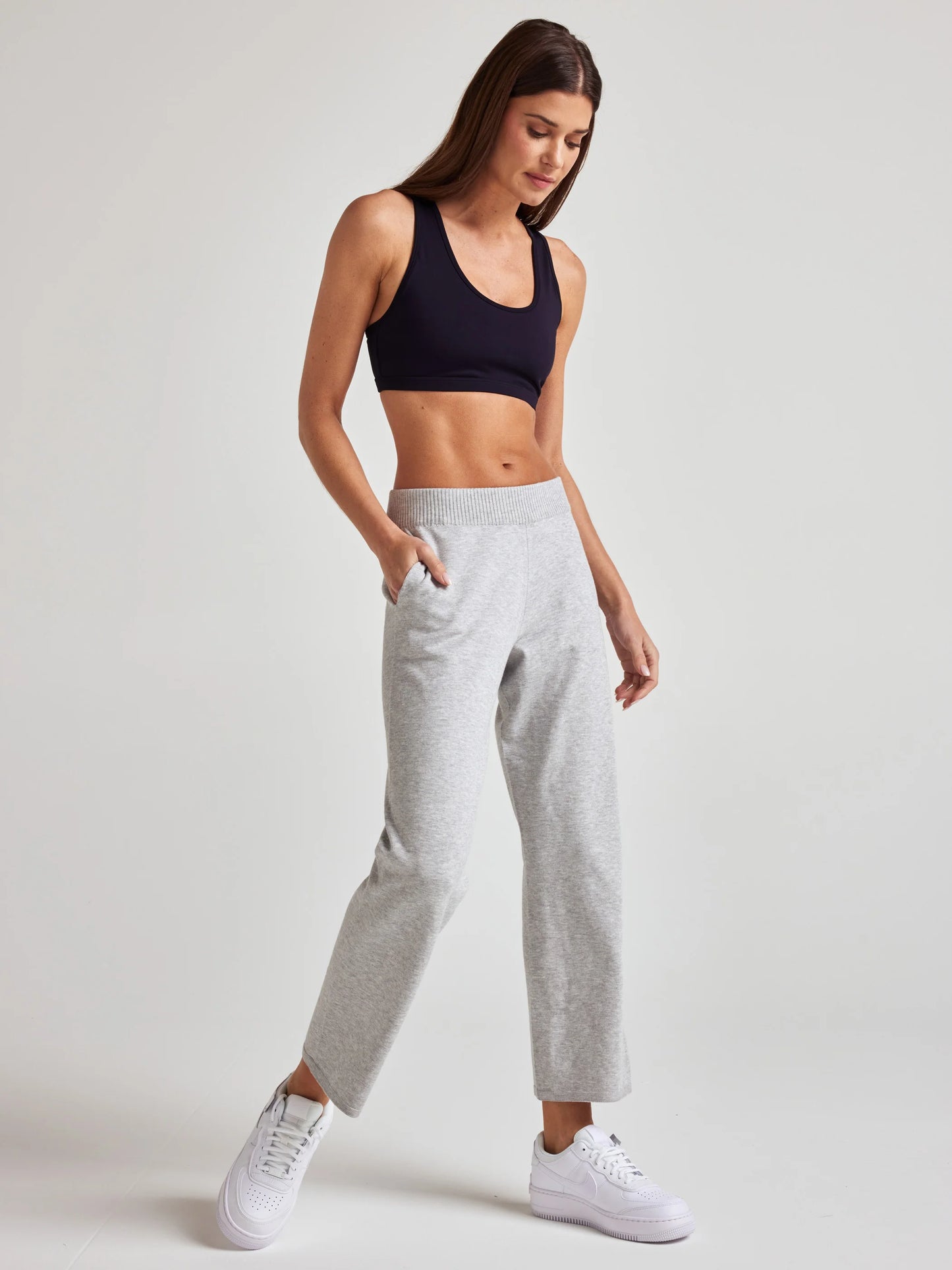 model wears sustainable cropped grey knit pants
