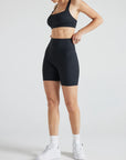 Model wears sustainable square neck black nylon rib sports bra