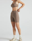 Model wears sustainable square neck light brown nylon rib sports bra