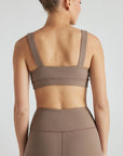 Model wears sustainable square neck light brown nylon rib sports bra
