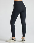Model wears sustainable black nylon rib leggings