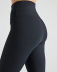 Model wears sustainable black nylon rib leggings