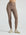 Model wears sustainable light brown nylon rib leggings
