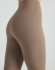 Model wears sustainable light brown nylon rib leggings