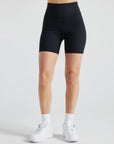 Model wears sustainable black nylon rib biker shorts