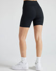 Model wears sustainable black nylon rib biker shorts