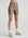 Model wears sustainable light brown nylon rib biker shorts