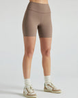 Model wears sustainable light brown nylon rib biker shorts