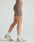 Model wears sustainable light brown nylon rib biker shorts