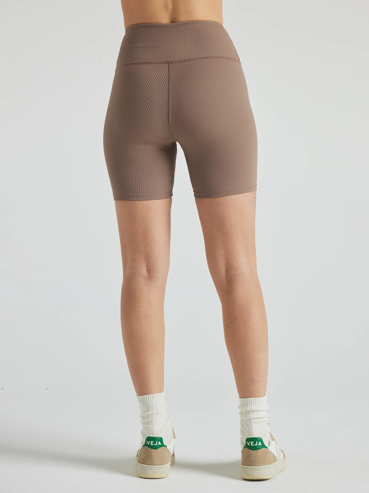 Model wears sustainable light brown nylon rib biker shorts