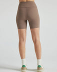 Model wears sustainable light brown nylon rib biker shorts