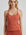 model poses in burnt orange corset tank
