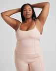 model poses in ballet-pink corset tank