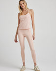 model poses in ballet-pink corset tank