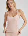 model poses in ballet-pink corset tank