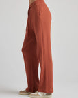 model wears relaxed waffle knit pants in baked clay