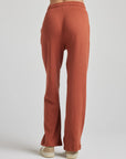 model wears relaxed waffle knit pants in baked clay
