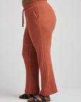 model wears relaxed waffle knit pants in baked clay