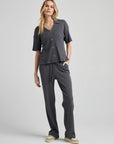 model wears relaxed waffle knit pants in charcoal