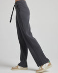 model wears relaxed waffle knit pants in charcoal