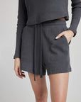 model wears retro waffle knit gym shorts in charcoal