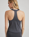 model wears grey racerback tank with built in bra