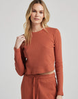 model wears organic thermal long sleeve in orange