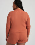 model wears organic thermal long sleeve in orange