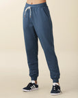 model wears cozy sustainable joggers with pockets in blue