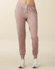 model wears cozy sustainable joggers with pockets in blush
