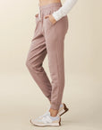 model wears cozy sustainable joggers with pockets in blush