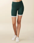 model wears green biker shorts with deep pockets