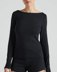 model wears black boat neck long sleeve