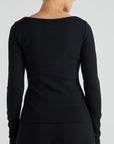 model wears black boat neck long sleeve