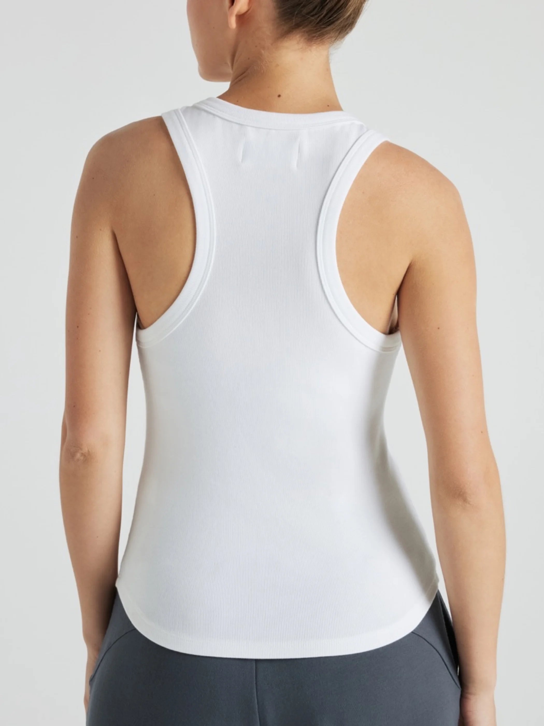 Model wears white luxury ribbed tank