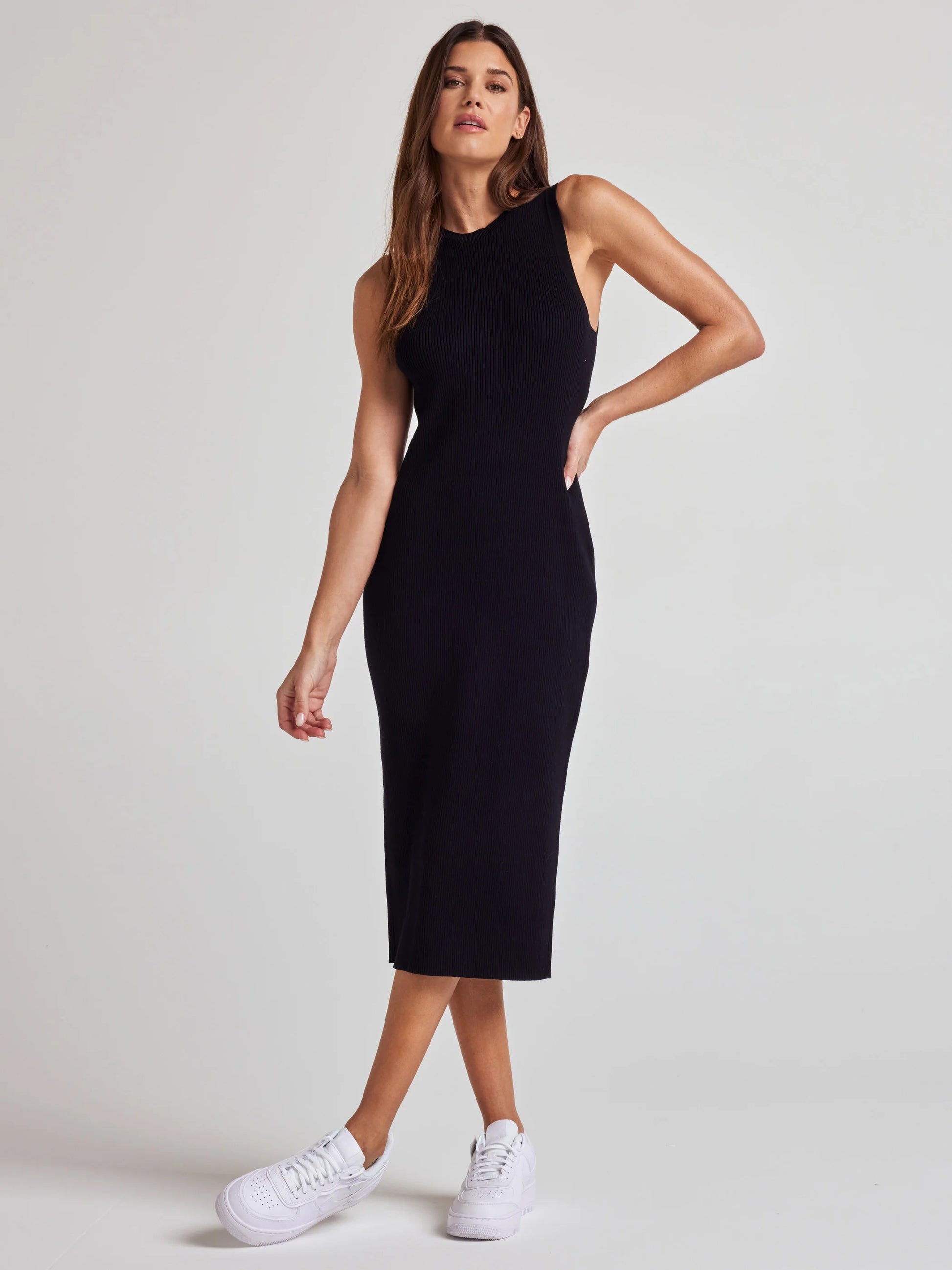 model wears sustainable black knit midi dress