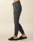 model wears cozy sustainable joggers with pockets in grey