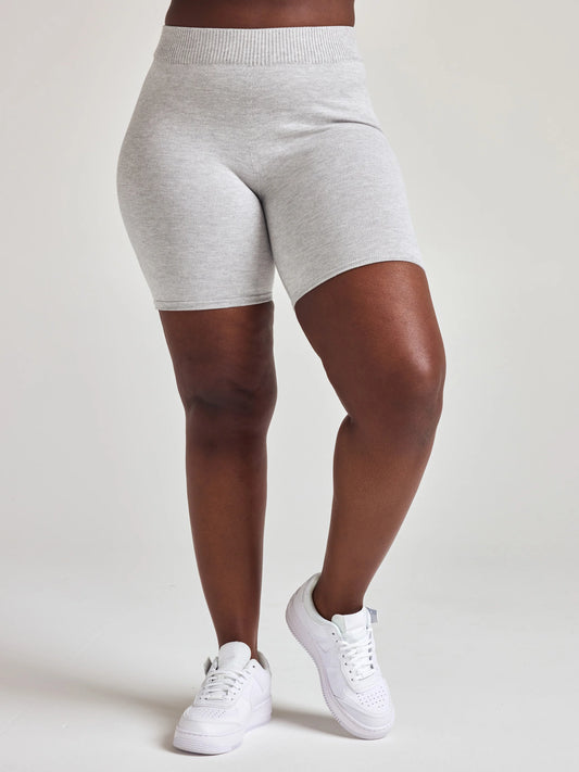 Model wears light grey knit biker shorts with 7 1/2 inch inseam