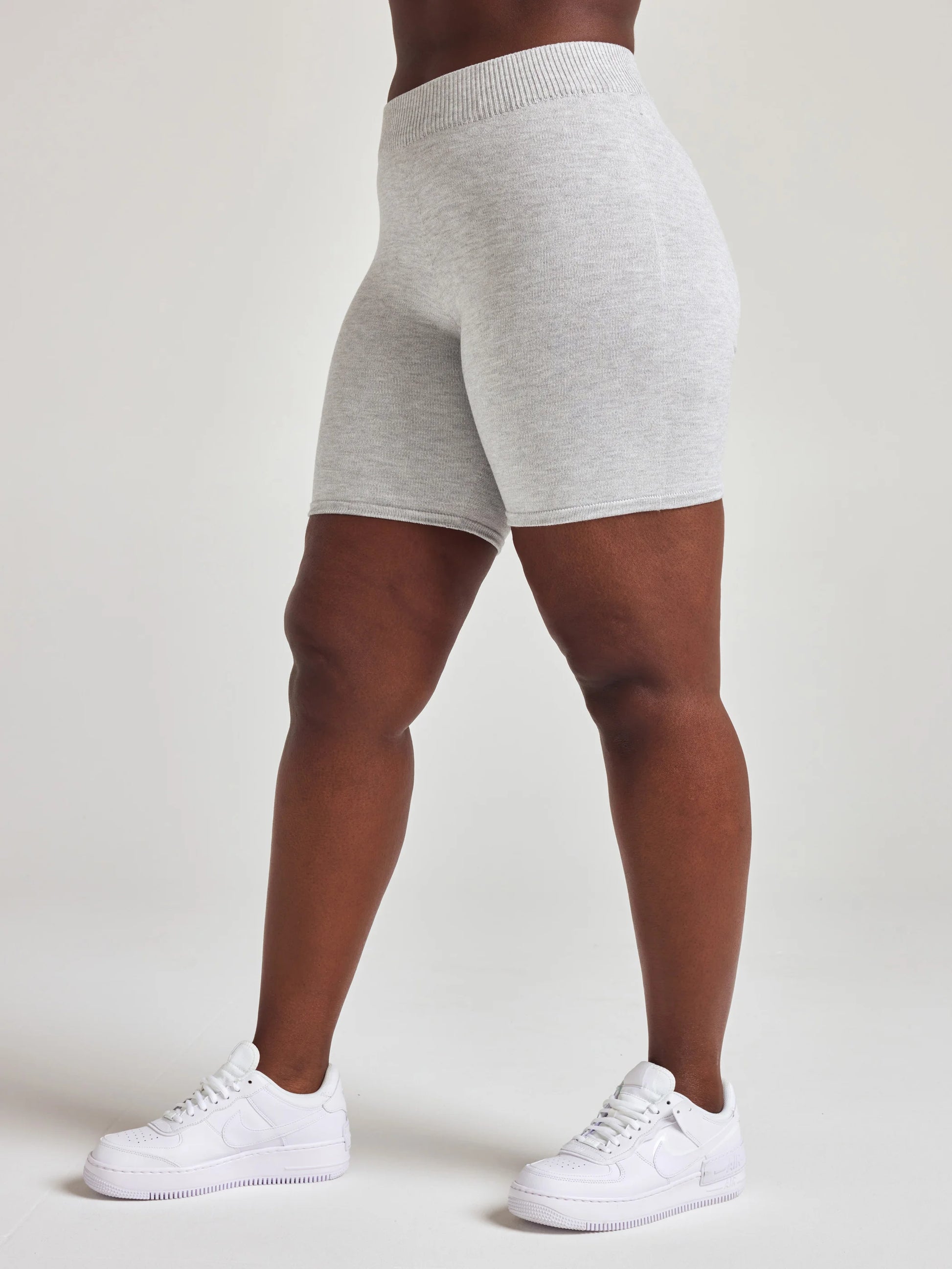 Model wears light grey knit biker shorts with 7 1/2 inch inseam