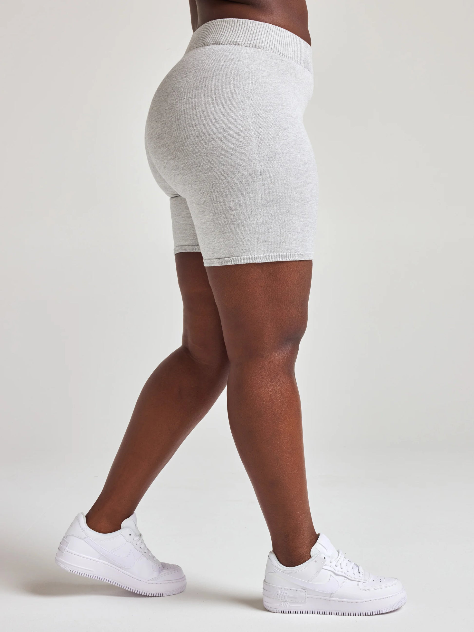 Model wears light grey knit biker shorts with 7 1/2 inch inseam