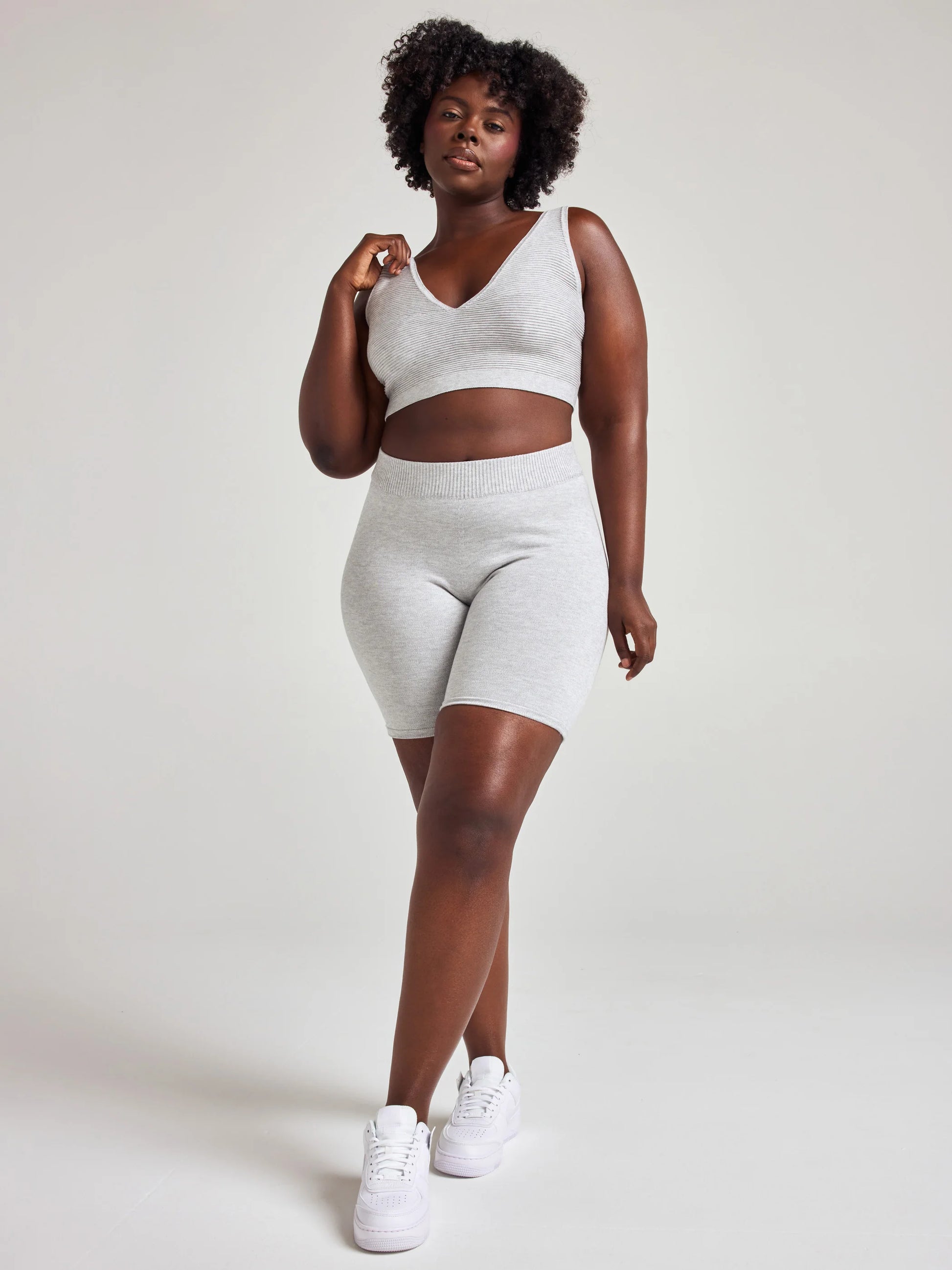 Model wears light grey knit biker shorts with 7 1/2 inch inseam