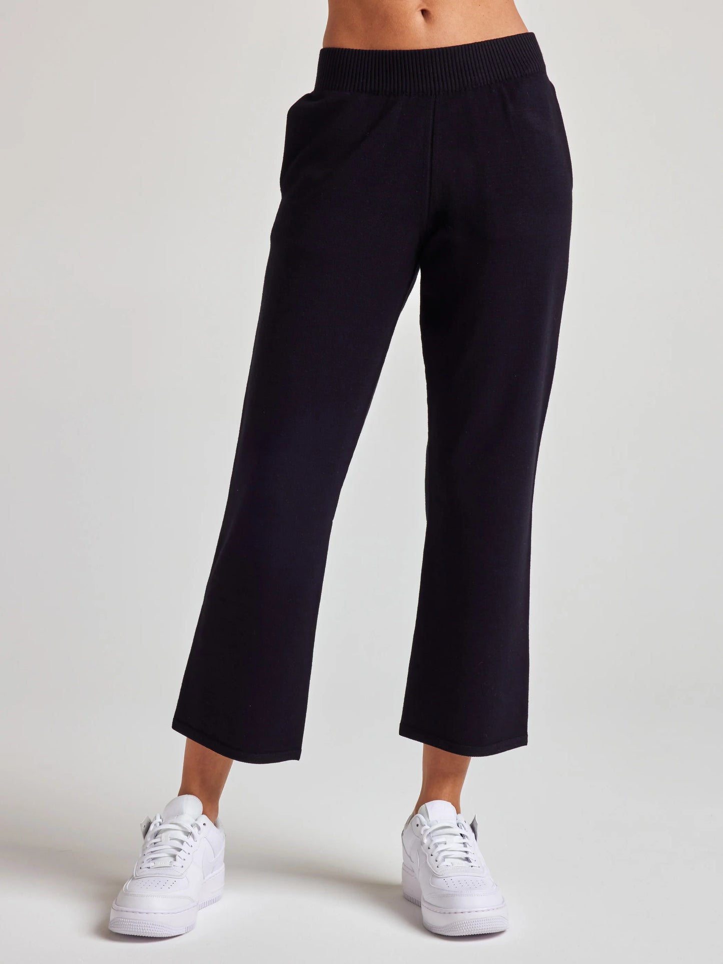 model wears sustainable cropped black knit pants