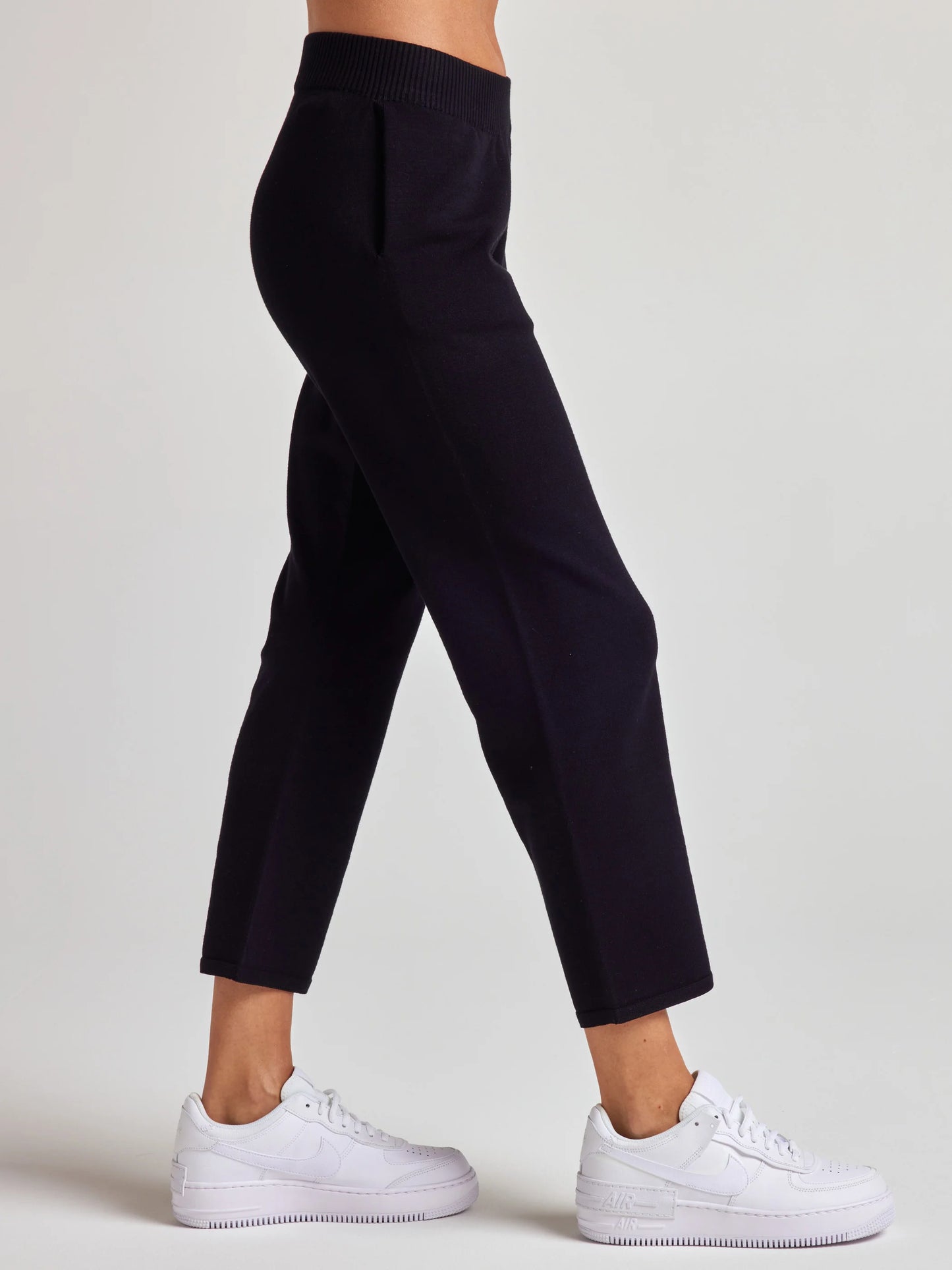 model wears sustainable cropped black knit pants