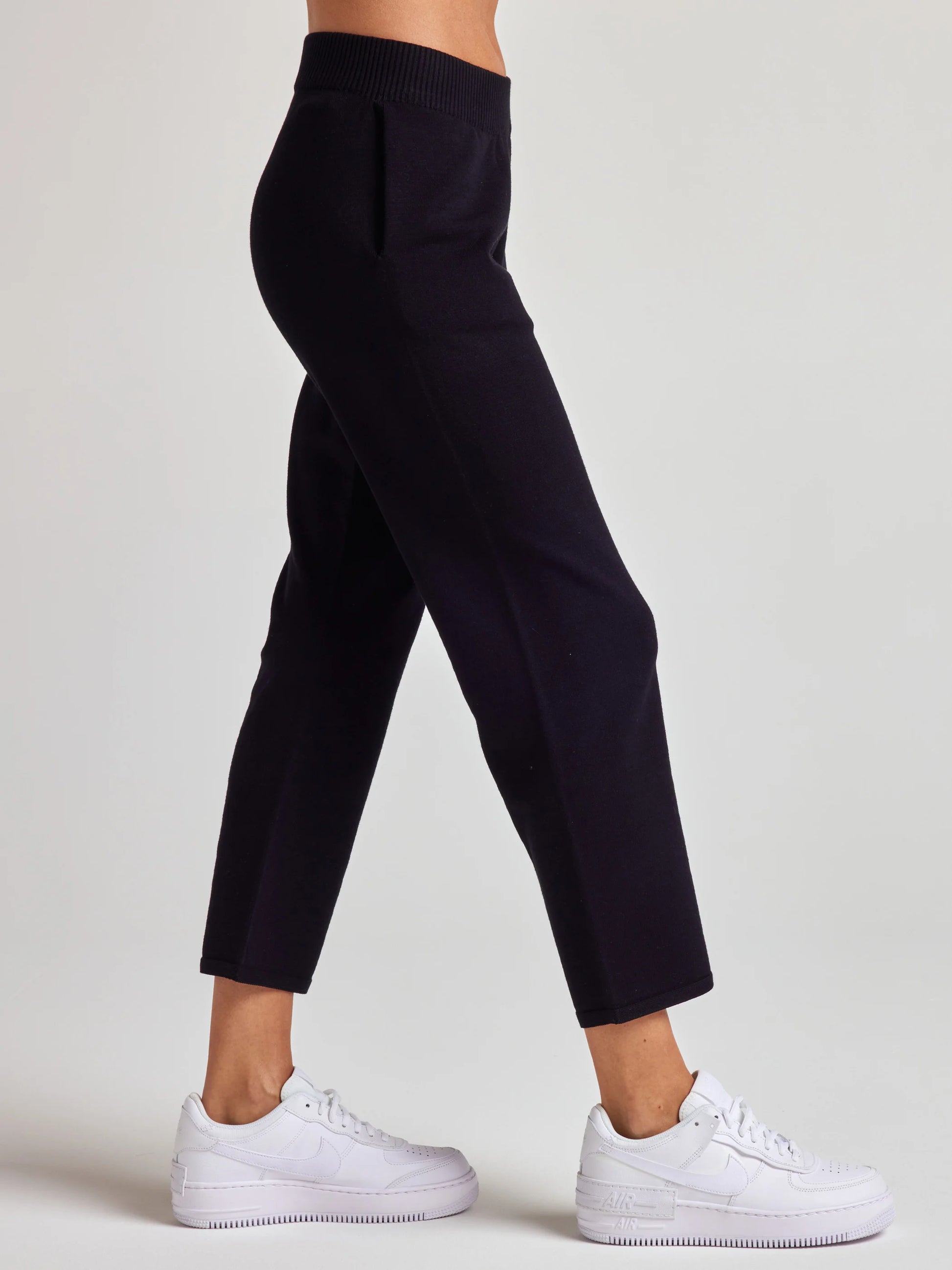 model wears sustainable cropped black knit pants