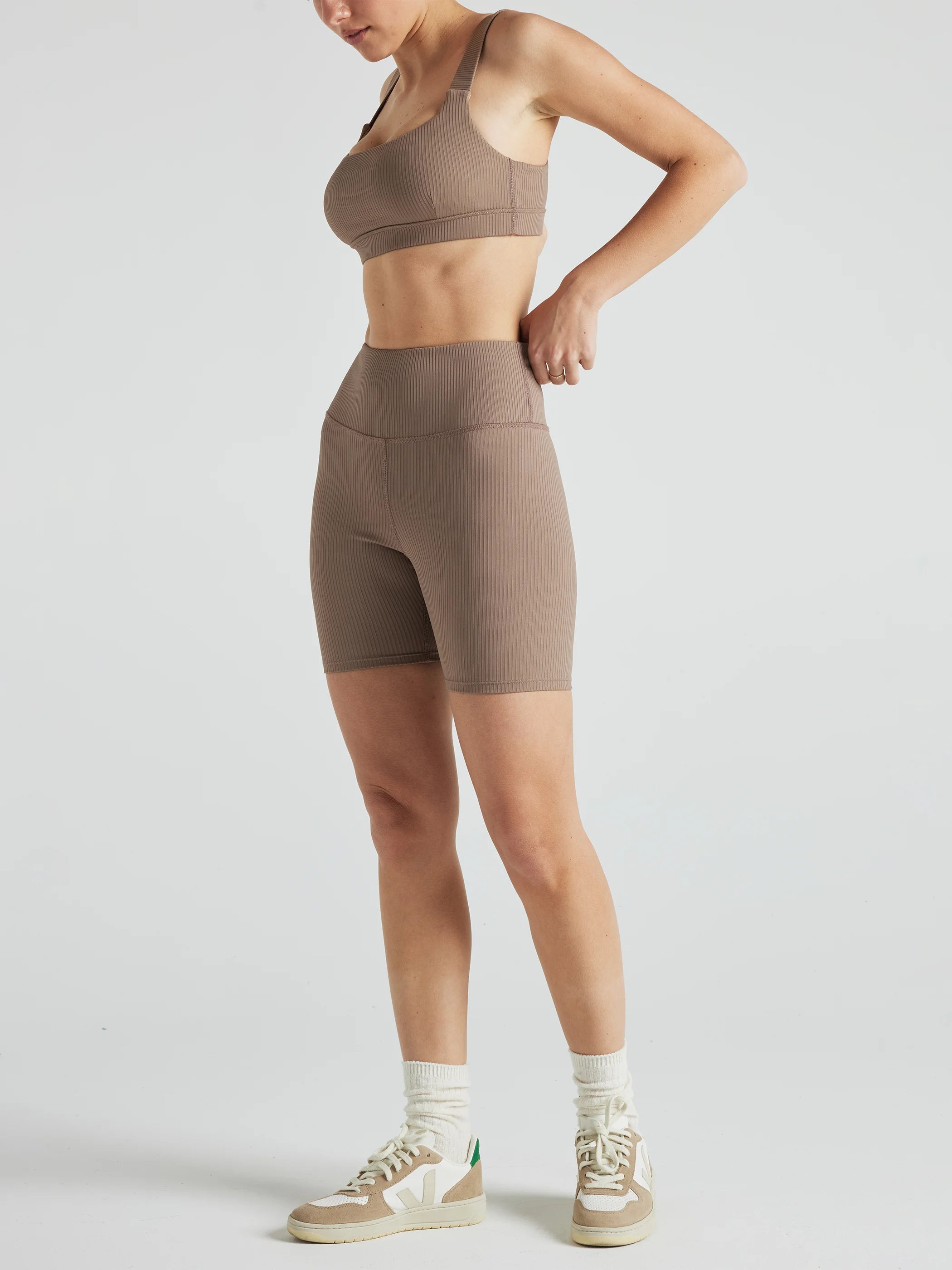 Model wears sustainable square neck light brown nylon rib sports bra
