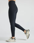 Model wears sustainable black nylon rib leggings
